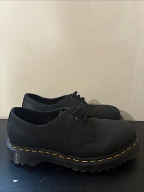 Dr. Martens 1461 leather oxfords feature the brand's signature yellow size 8